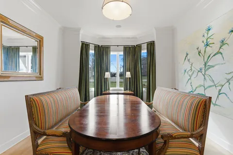 a view of a dining room with furniture wooden floor and chandelier
