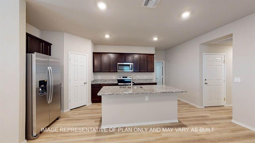 3201 Cyprian Road Lorena, TX 76655 - Photo 3 of 27 a large kitchen with stainless steel appliances granite countertop a large counter top and a wooden floors