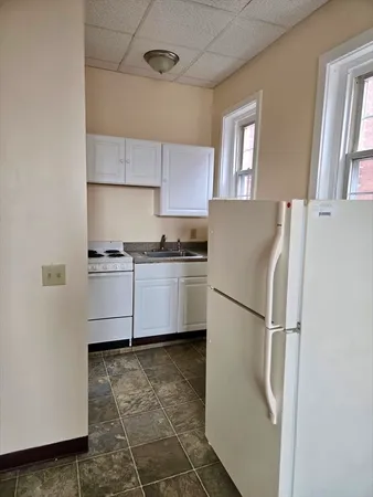 a white refrigerator freezer sitting in a kitchen