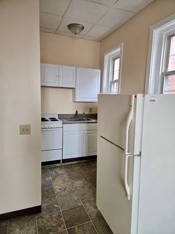 a white refrigerator freezer sitting in a kitchen