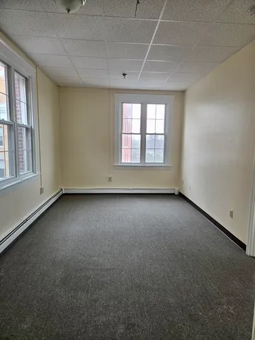an empty room with a empty space and windows