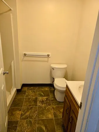 a bathroom with a toilet and a shower