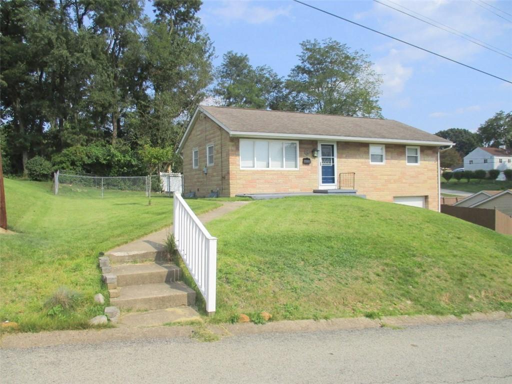 a view of a house with a yard and a garden