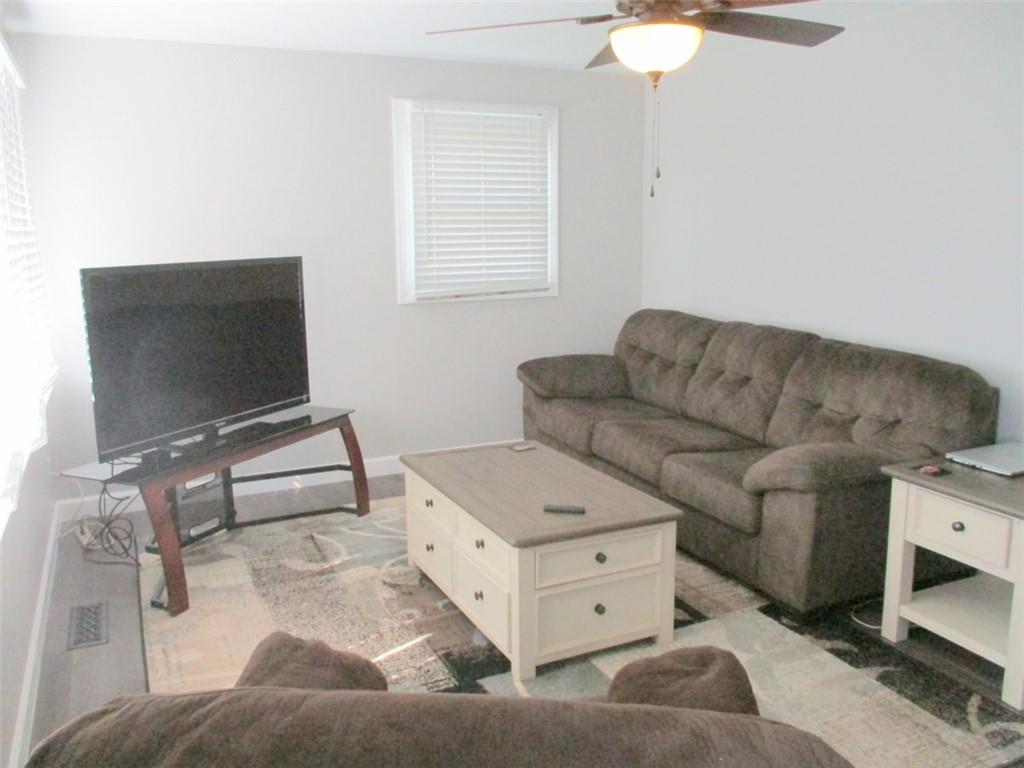 24 Russell Street Baden, PA 15005 - Photo 12 of 31 a living room with furniture and a flat screen tv