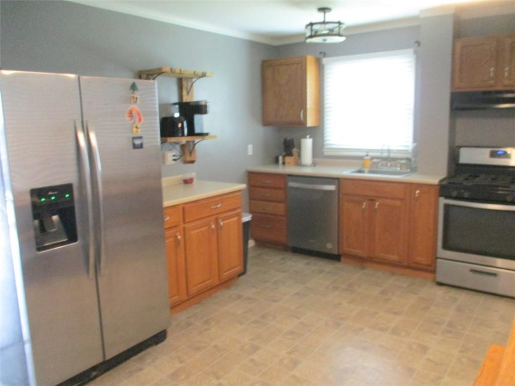 24 Russell Street Baden, PA 15005 - Photo 13 of 31 a kitchen with stainless steel appliances granite countertop a refrigerator sink and stove