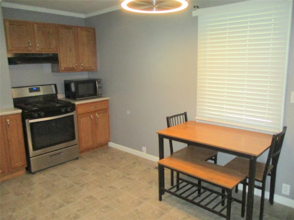 24 Russell Street Baden, PA 15005 - Photo 14 of 31 a room with wooden furniture and a window