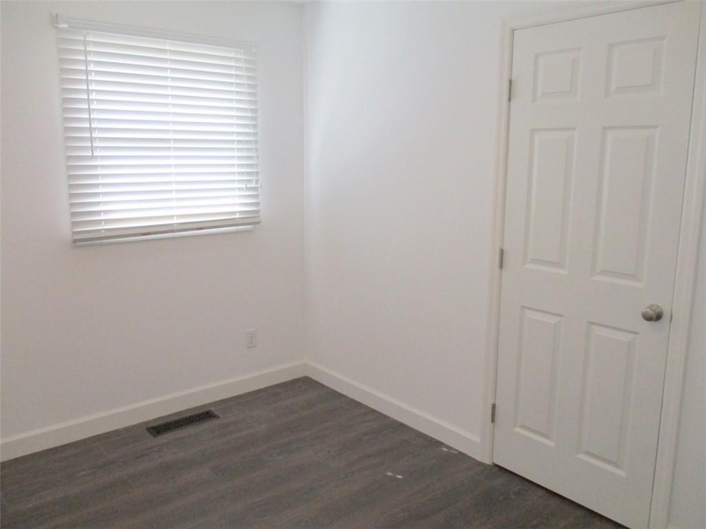 24 Russell Street Baden, PA 15005 - Photo 18 of 31 an empty room with wooden floor and windows