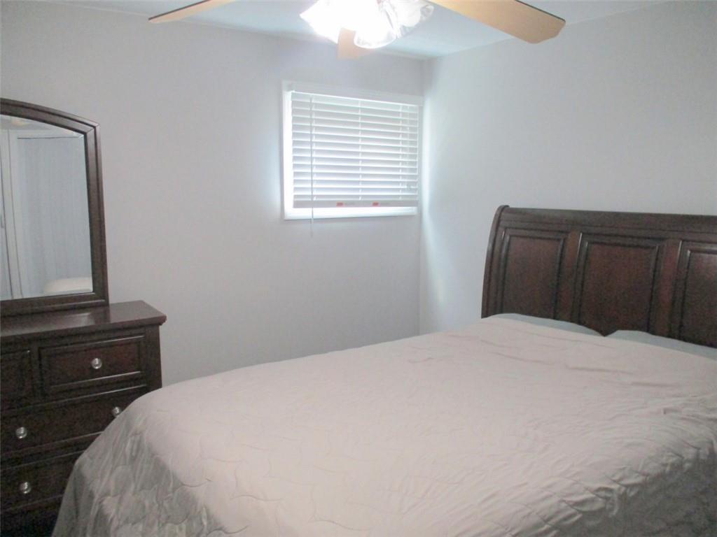 24 Russell Street Baden, PA 15005 - Photo 22 of 31 a bedroom with a bed and a mirror