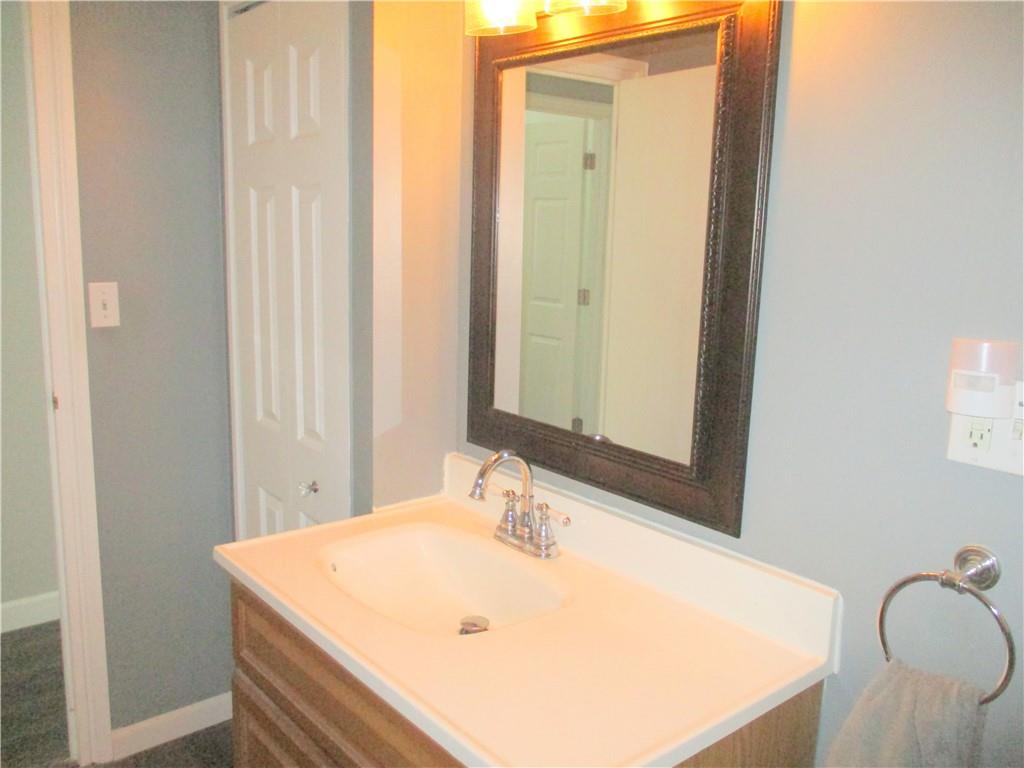 24 Russell Street Baden, PA 15005 - Photo 26 of 31 a bathroom with a sink and a mirror