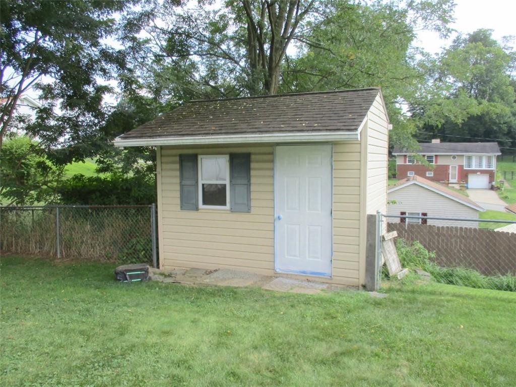 24 Russell Street Baden, PA 15005 - Photo 8 of 31 a view of a backyard with barn plants and large tree