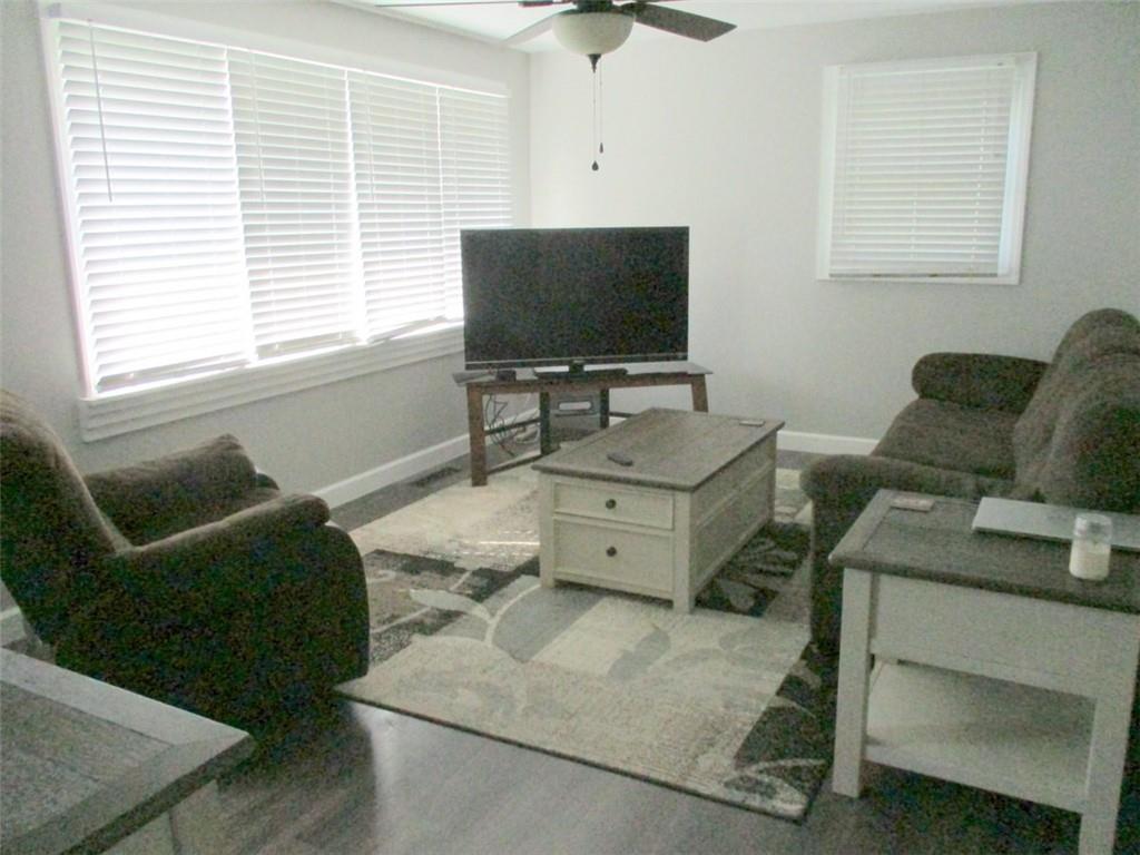 24 Russell Street Baden, PA 15005 - Photo 10 of 31 a living room with furniture and a flat screen tv