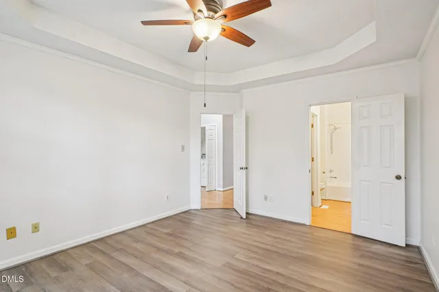 an empty room with wooden floor and door