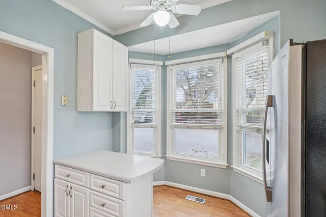 a kitchen with a refrigerator a sink and cabinets