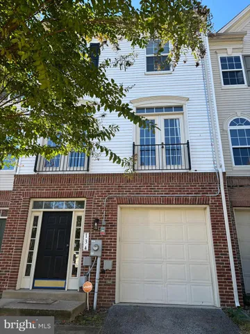 a view of an entryway with wooden floor and door