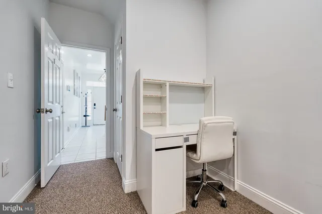 a view of room with cabinet and hallway
