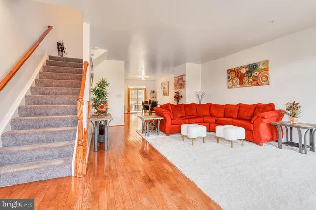 a living room with furniture and stairs