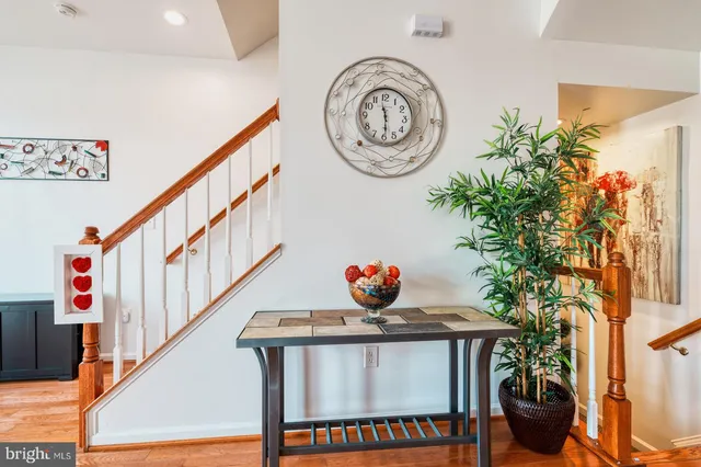 a view of a dining room with furniture a chandelier and wooden floor
