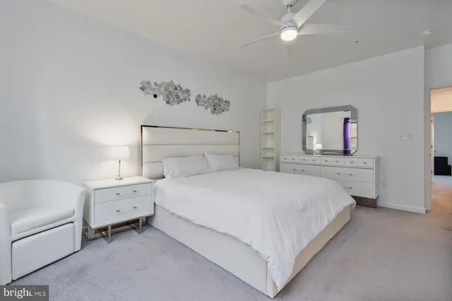 a spacious bedroom with a bed and a window