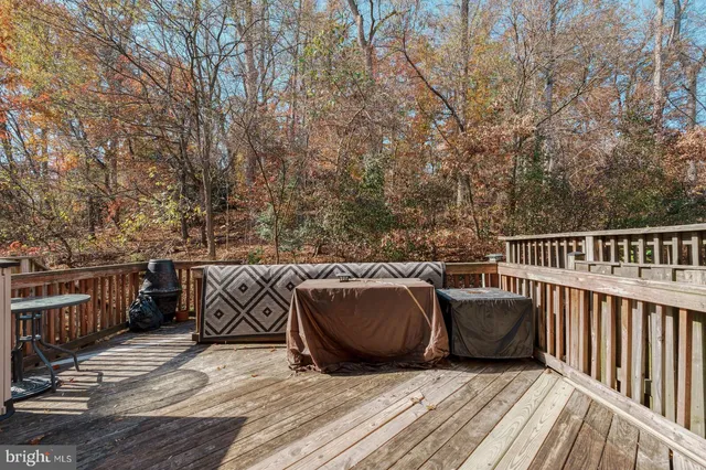 a view of roof deck with furniture and trees
