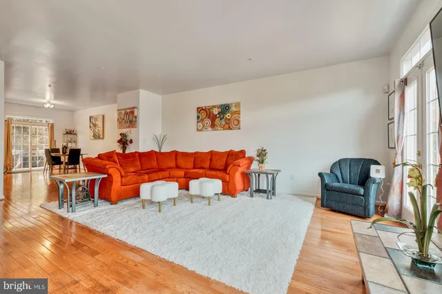 a living room with furniture a rug and a lamp