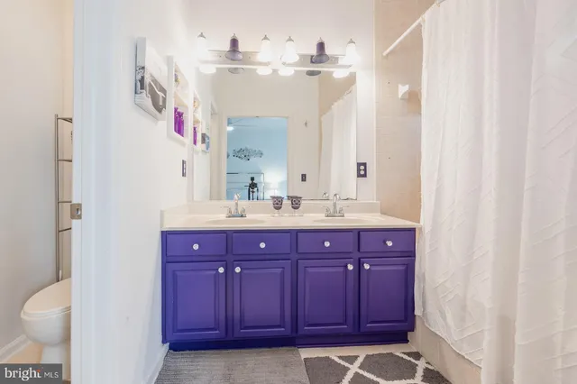 a bathroom with a sink vanity and a mirror