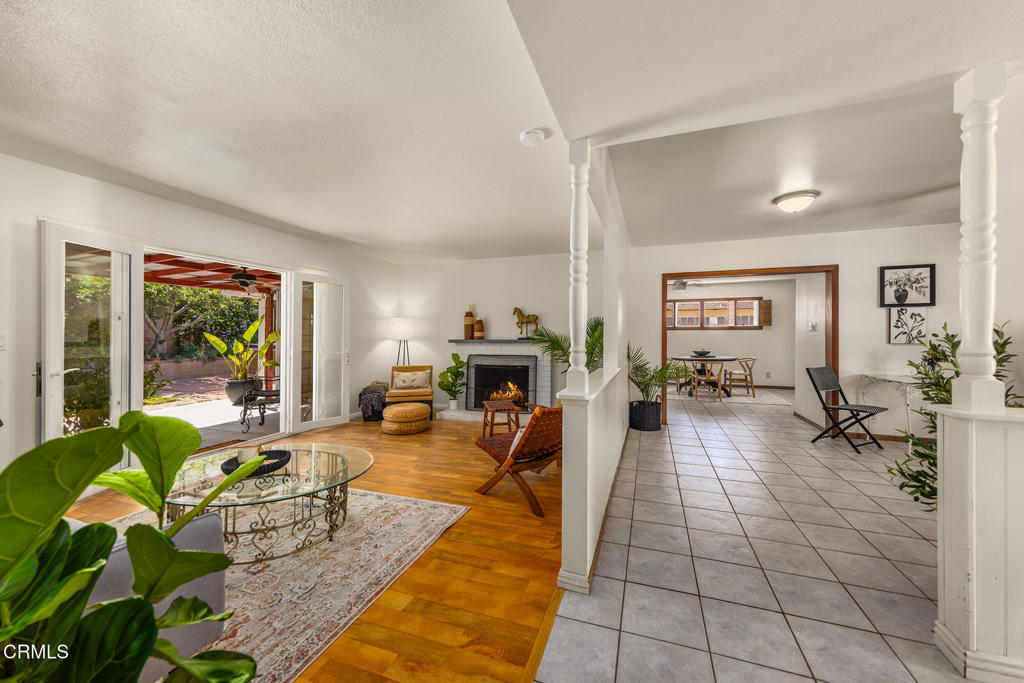 40 Almond Avenue Oak View, CA 93022 - Photo 7 of 30 a living room with furniture a fireplace a rug potted plant and a large window