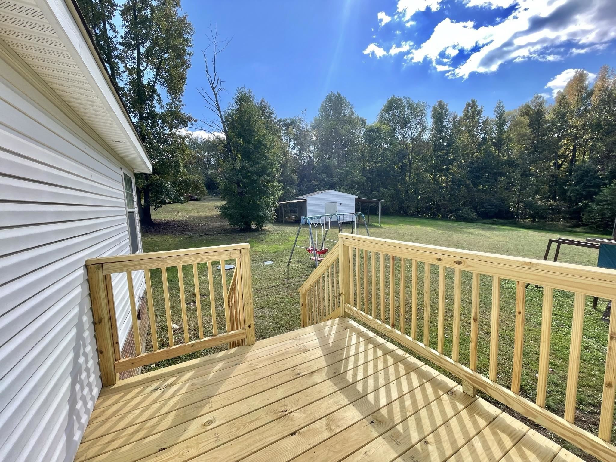 45 Divine Lane Roxboro, NC 27573 - Photo 25 of 28 a view of deck with furniture and trees