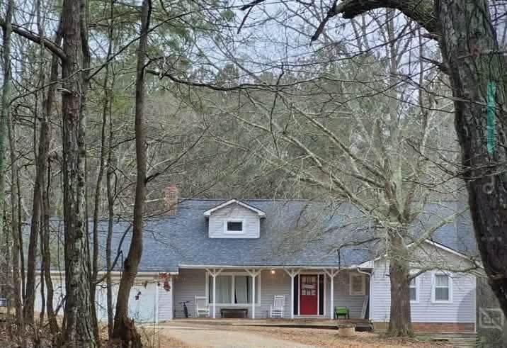 front view of a building with large trees