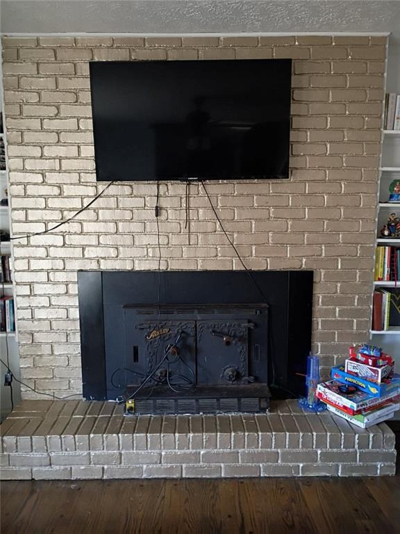 7130 Nantz Road Winston, GA 30187 - Photo 6 of 24 a living room with a fireplace and a flat screen tv
