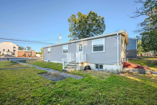 a view of backyard of house with green space