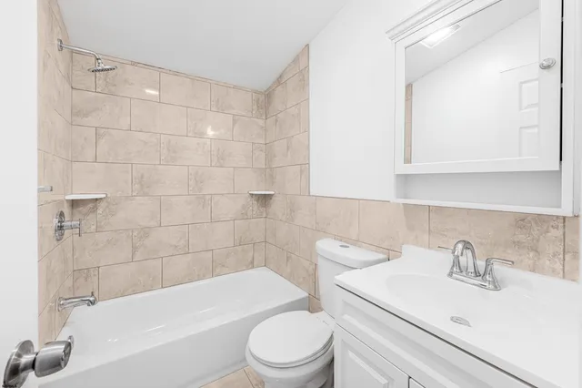 a bathroom with a sink a toilet and bathtub