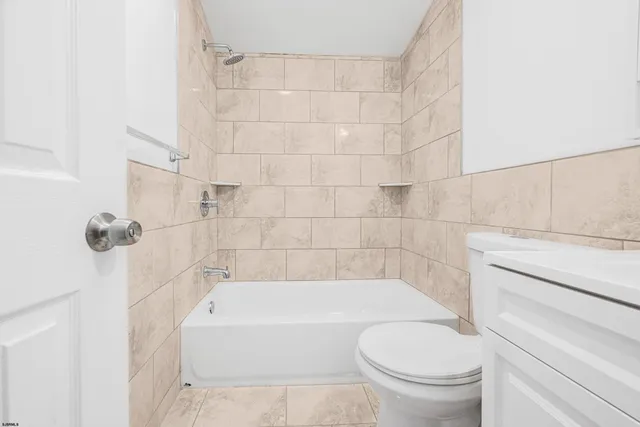 a bathroom with a bathtub and toilet