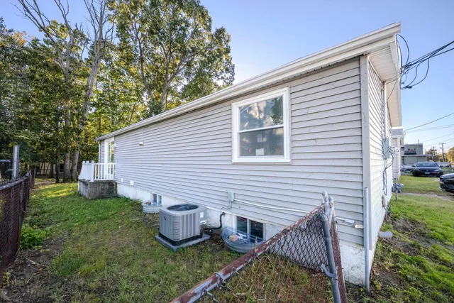 a view of a backyard with plants and a patio