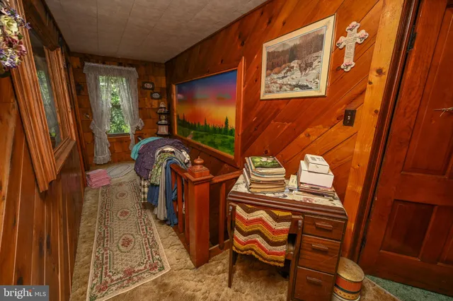 a view of a backyard with wooden fence and large trees