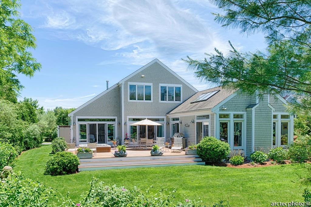 a front view of a house with porch and garden