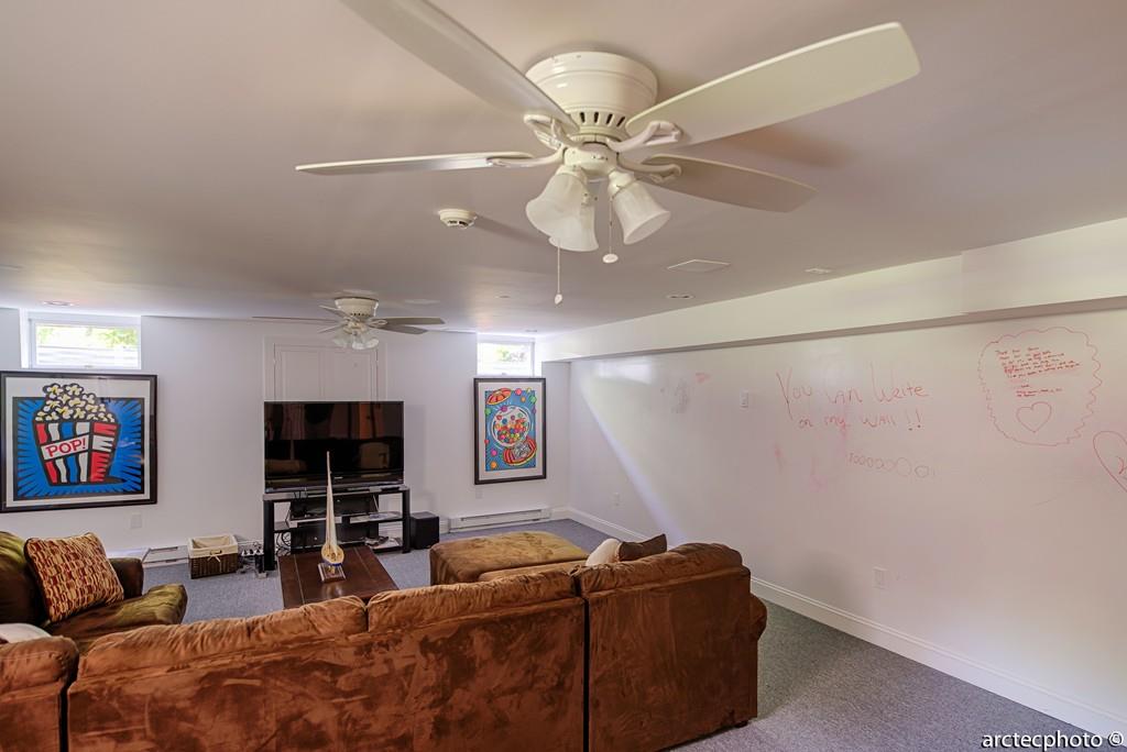 56 The Heights Mashpee, MA 02649 - Photo 11 of 16 a living room with furniture and a flat screen tv