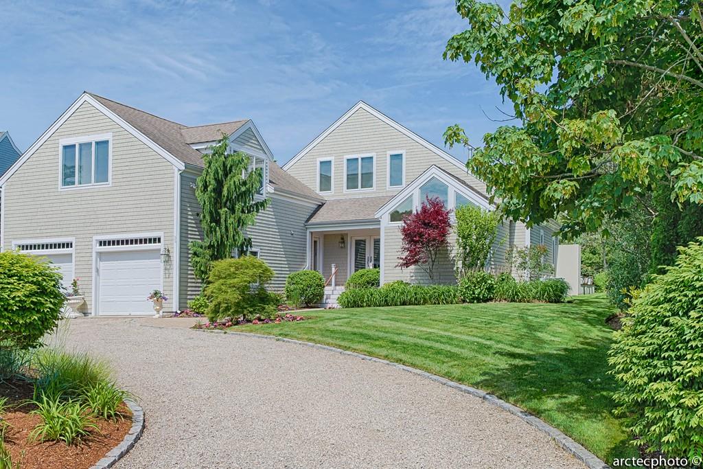 56 The Heights Mashpee, MA 02649 - Photo 3 of 16 a front view of house with yard and green space