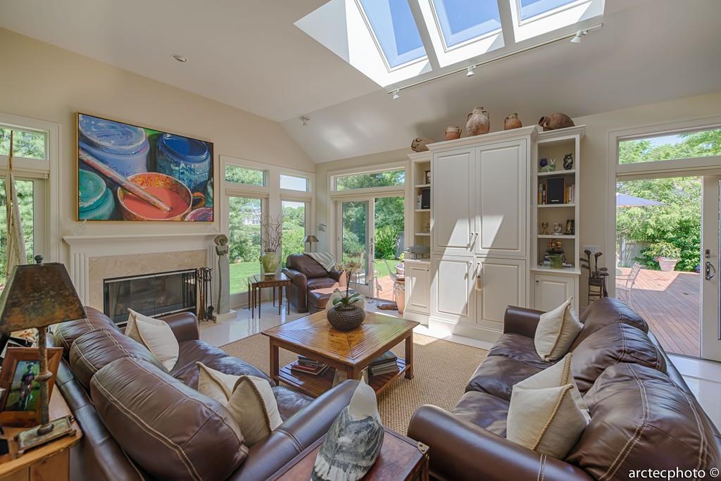 56 The Heights Mashpee, MA 02649 - Photo 7 of 16 a living room with furniture a fireplace and a large window