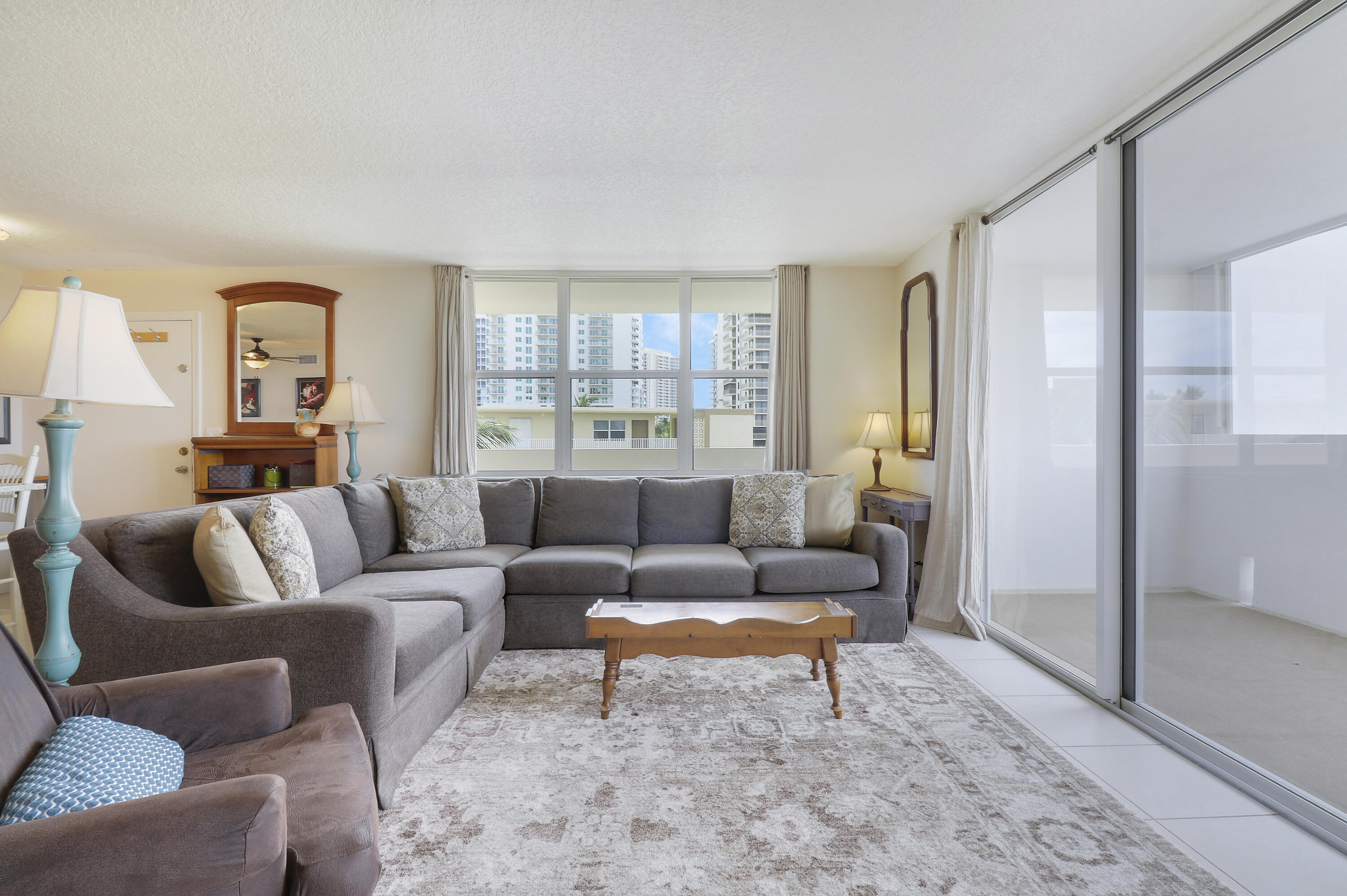3640 North Ocean Drive, Unit 427 Singer Island, FL 33404 - Photo 13 of 43 a living room with furniture and a window