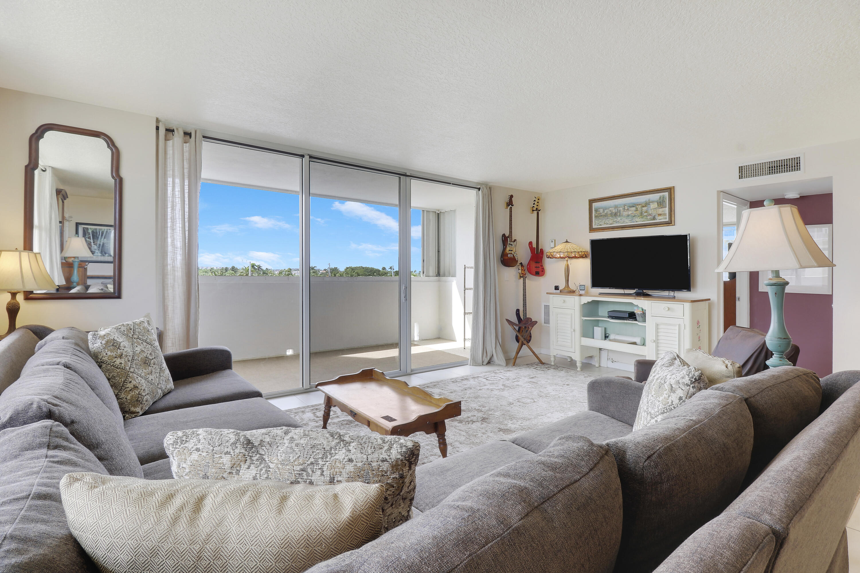 3640 North Ocean Drive, Unit 427 Singer Island, FL 33404 - Photo 16 of 43 a living room with furniture and a flat screen tv