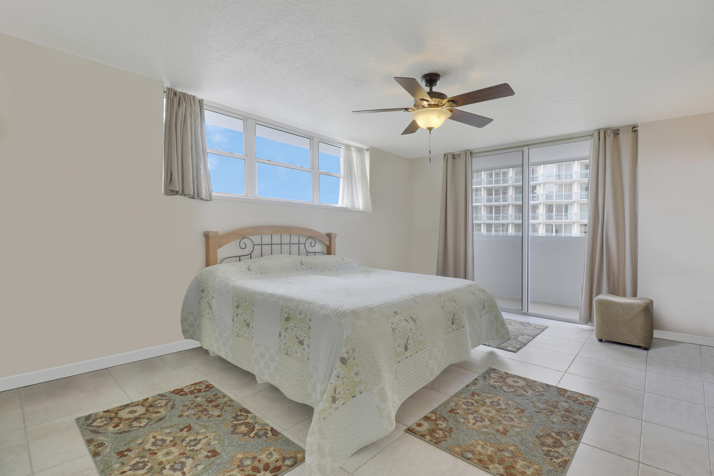3640 North Ocean Drive, Unit 427 Singer Island, FL 33404 - Photo 18 of 43 a spacious bedroom with a bed and a window