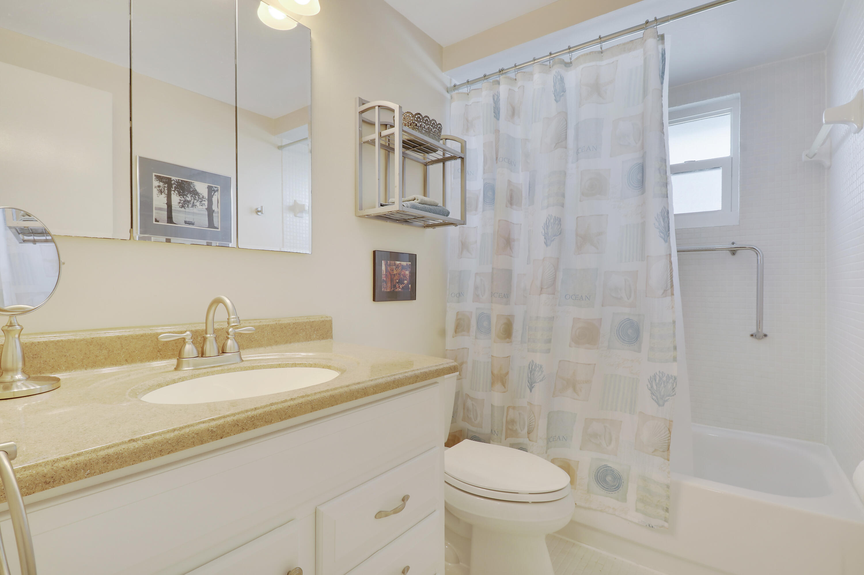 3640 North Ocean Drive, Unit 427 Singer Island, FL 33404 - Photo 24 of 43 a bathroom with a sink a toilet and shower