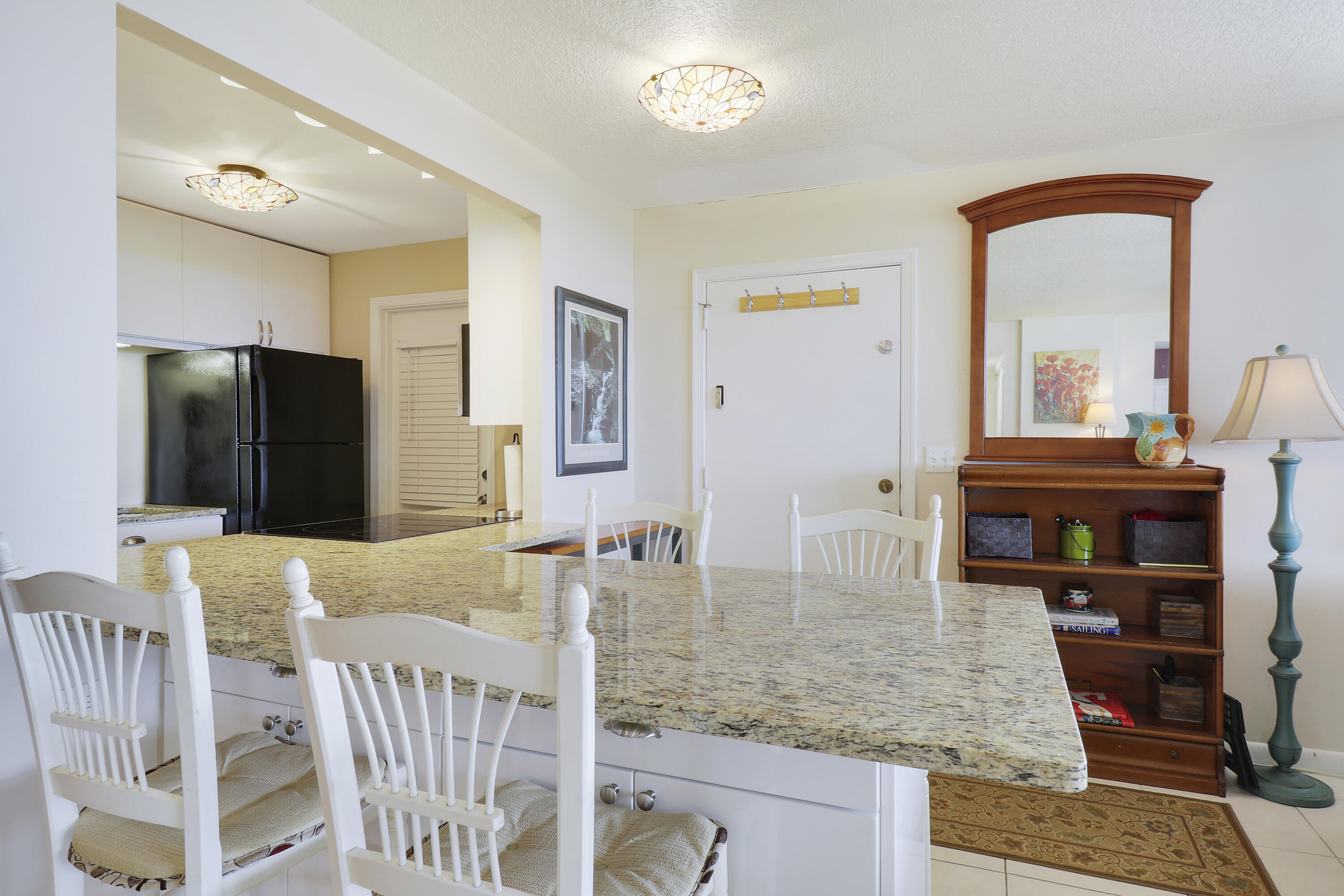 3640 North Ocean Drive, Unit 427 Singer Island, FL 33404 - Photo 7 of 43 a view of dining room and hall with furniture