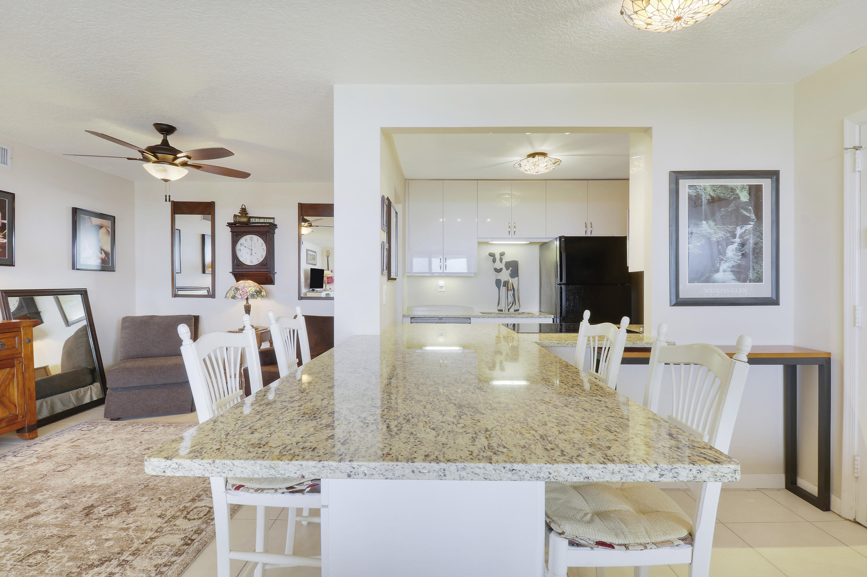 3640 North Ocean Drive, Unit 427 Singer Island, FL 33404 - Photo 8 of 43 a view of kitchen island a sink and living room