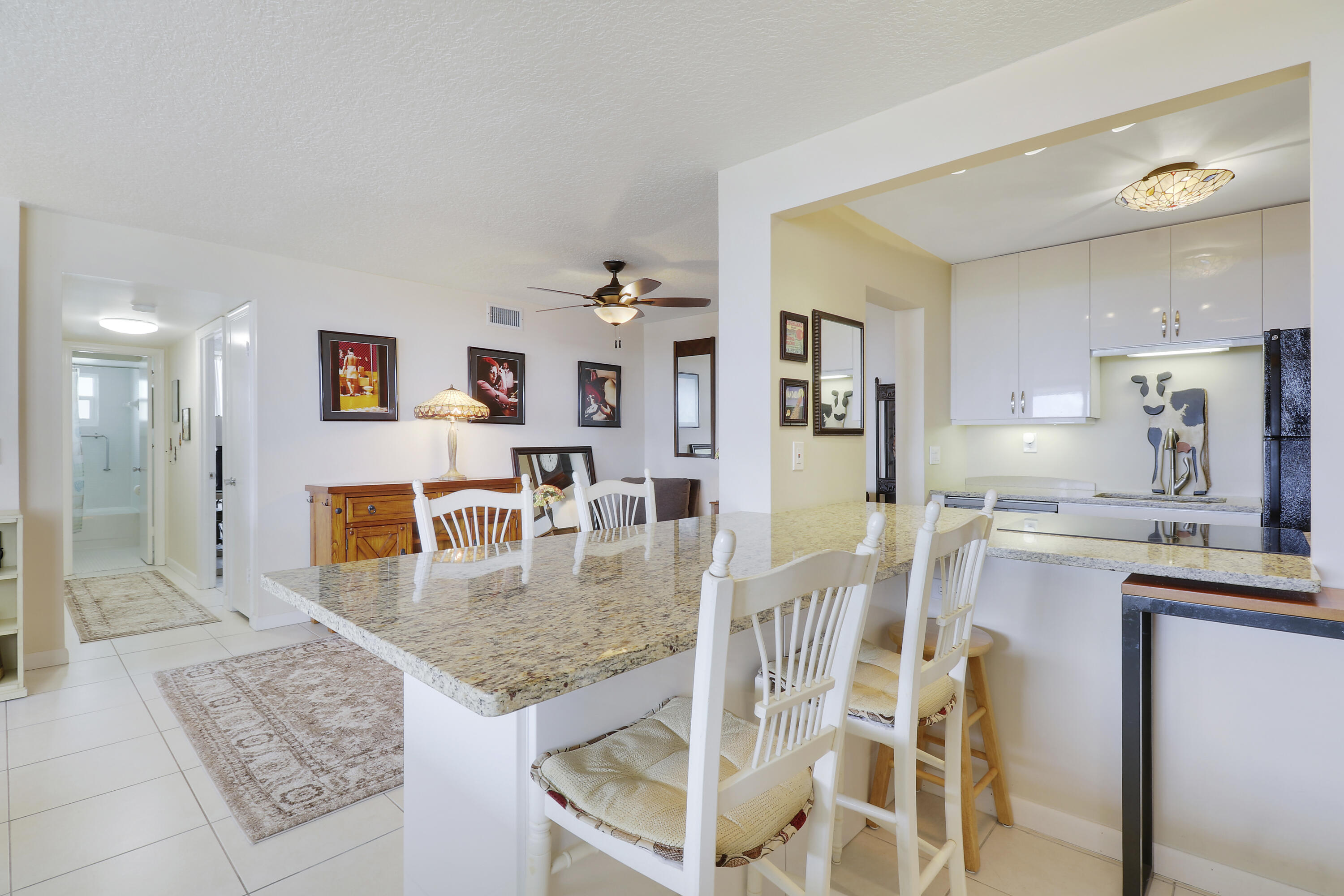 3640 North Ocean Drive, Unit 427 Singer Island, FL 33404 - Photo 9 of 43 a kitchen with stainless steel appliances granite countertop a refrigerator and microwave