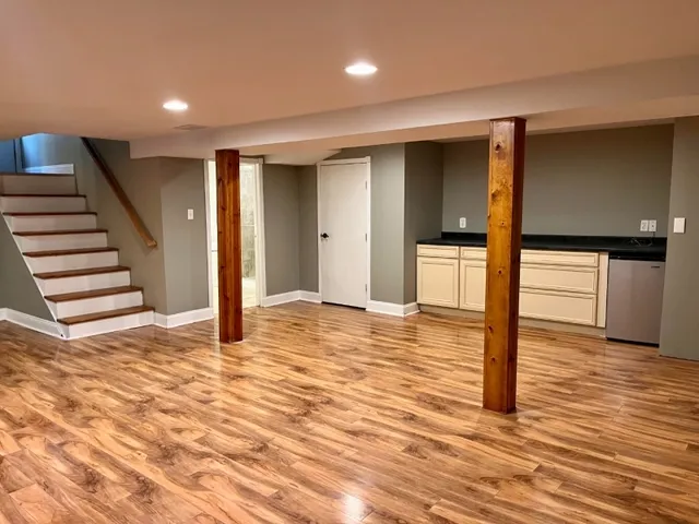 a view of empty room with wooden floor