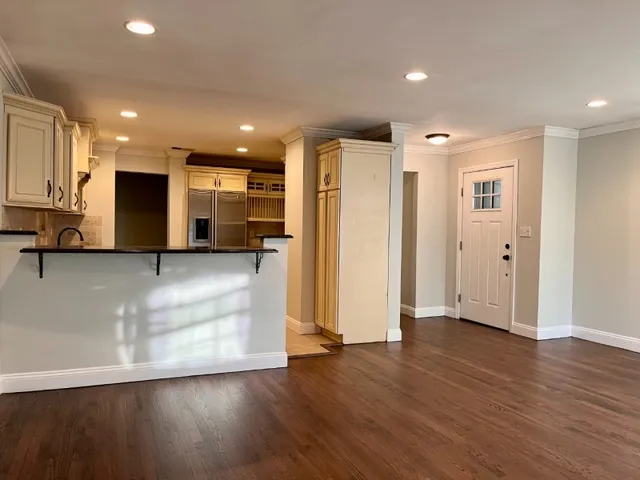 a view of kitchen with stainless steel appliances refrigerator sink and cabinets