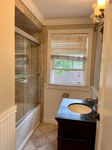 a bathroom with a sink a bathtub and shower