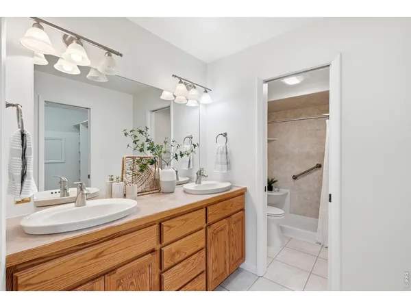 a bathroom with a sink a large mirror and a toilet
