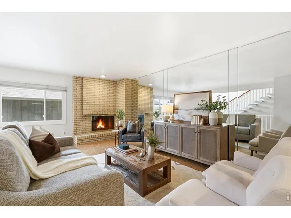 a kitchen with stainless steel appliances granite countertop a refrigerator a sink dishwasher a stove top oven a refrigerator with white cabinets and wooden floor
